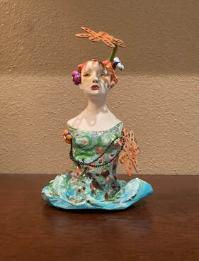 Ceramic sculptural figure with metal flower found objects